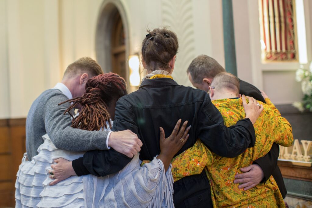 Mourners embracing at a funeral